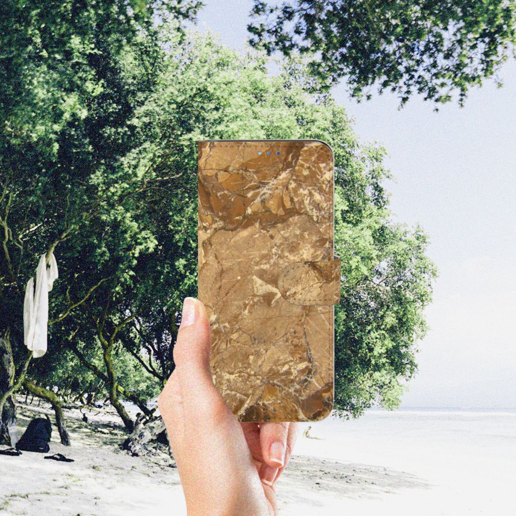OPPO Find X3 Neo 5G Bookcase Marmer Creme in hand by a beach with lush greenery in the background.