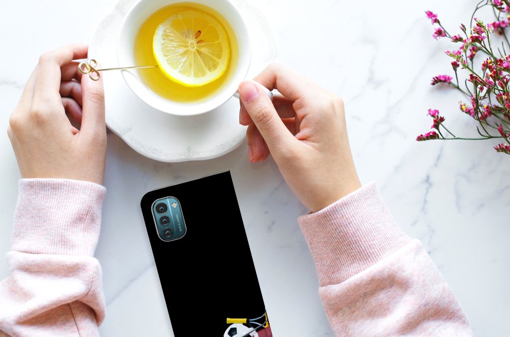 Nokia G11 | G21 Hippe Standcase Sports design displayed with hands holding a cup of lemon tea.