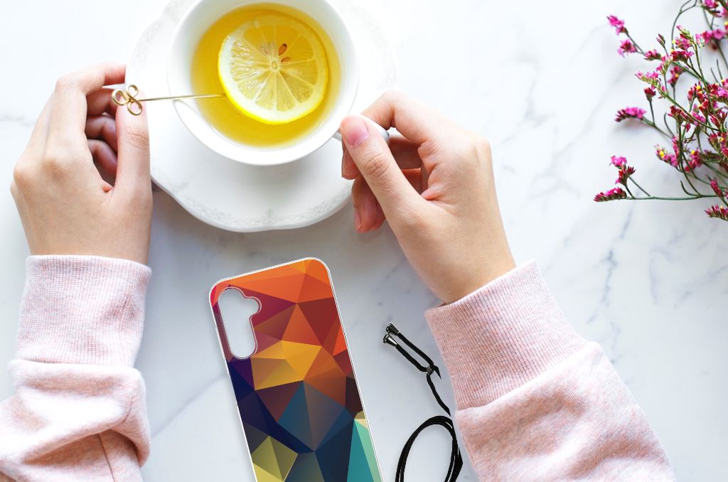 Samsung Galaxy A14 5G Shockproof Case Polygon Color on a table with a cup of tea and fresh lemon slices.