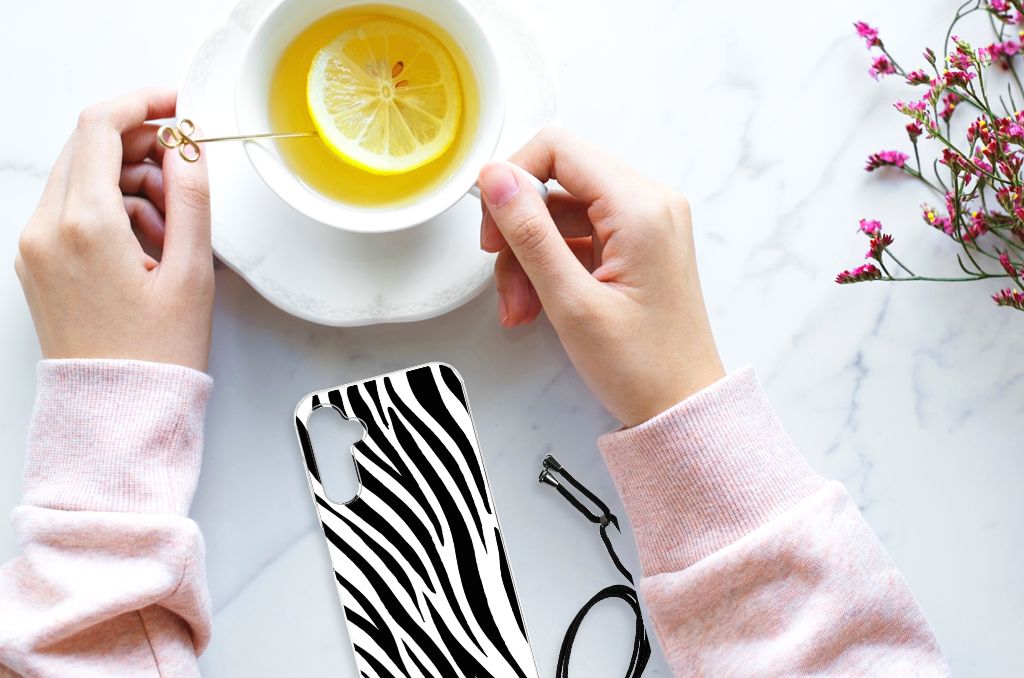 Samsung Galaxy A14 5G Case Anti-shock Zebra design displayed next to a cup of tea.