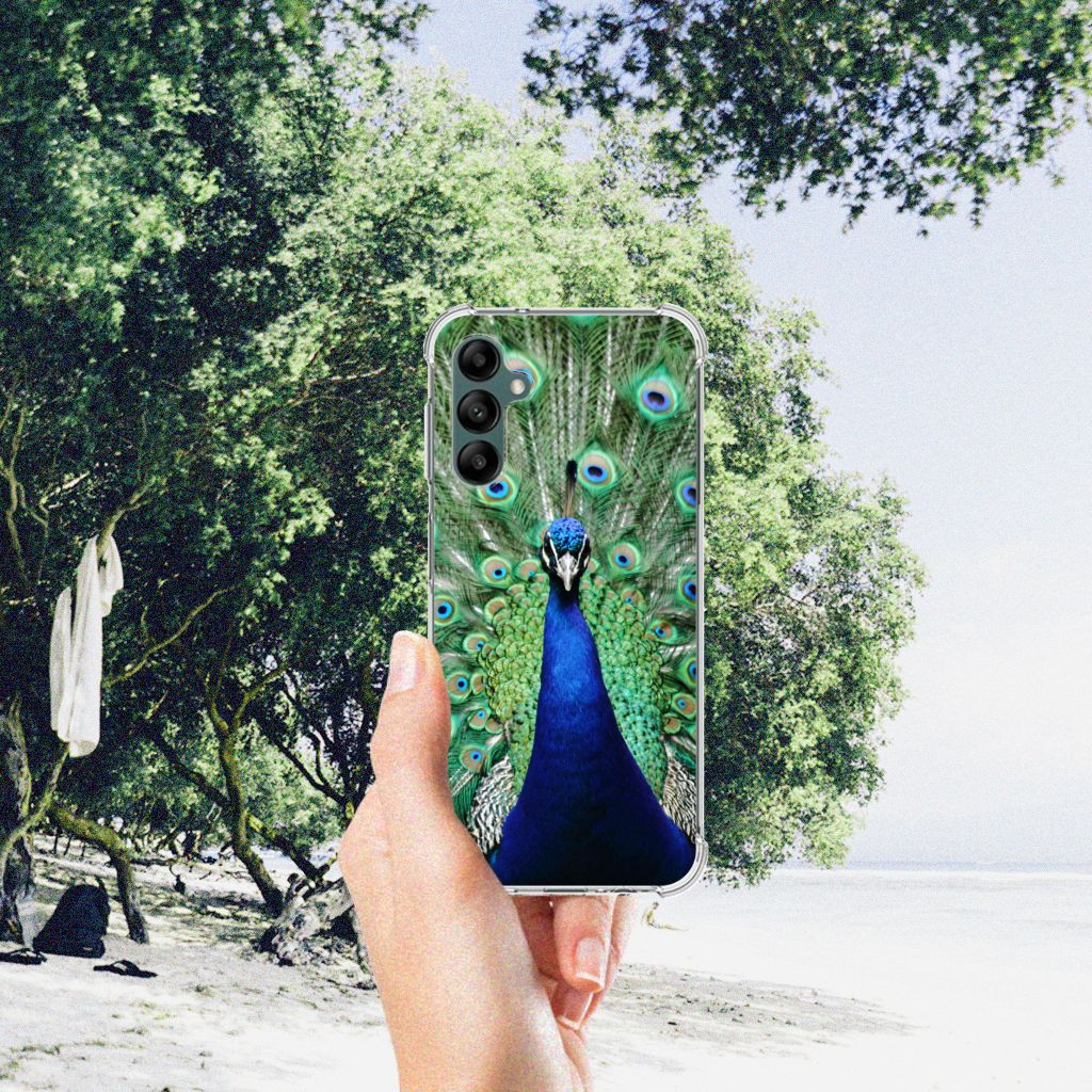 Samsung Galaxy A14 5G/4G Case Anti-shock Pauw in hand, showcasing colorful peacock design at the beach.