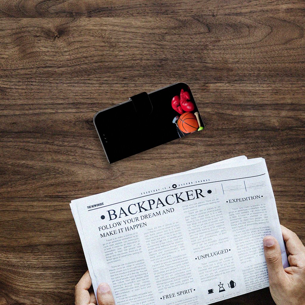 Apple iPhone 14 Wallet Case met Pasjes Sports op een houten tafel met een krant