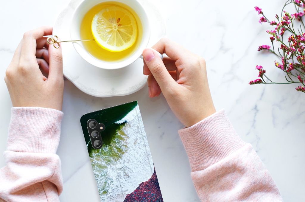 Samsung Galaxy A14 4G Stand Case Sea in Space on a table with tea and flowers.