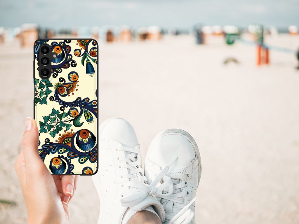 Back Cover Samsung Galaxy A14 5G Barok Flower held by a person in white sneakers on the beach.