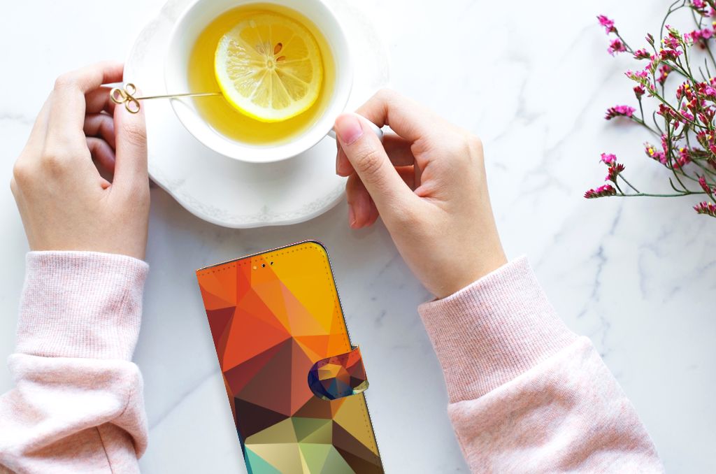 Samsung Galaxy A14 5G Book Case Polygon Color placed next to a cup of tea with lemon.