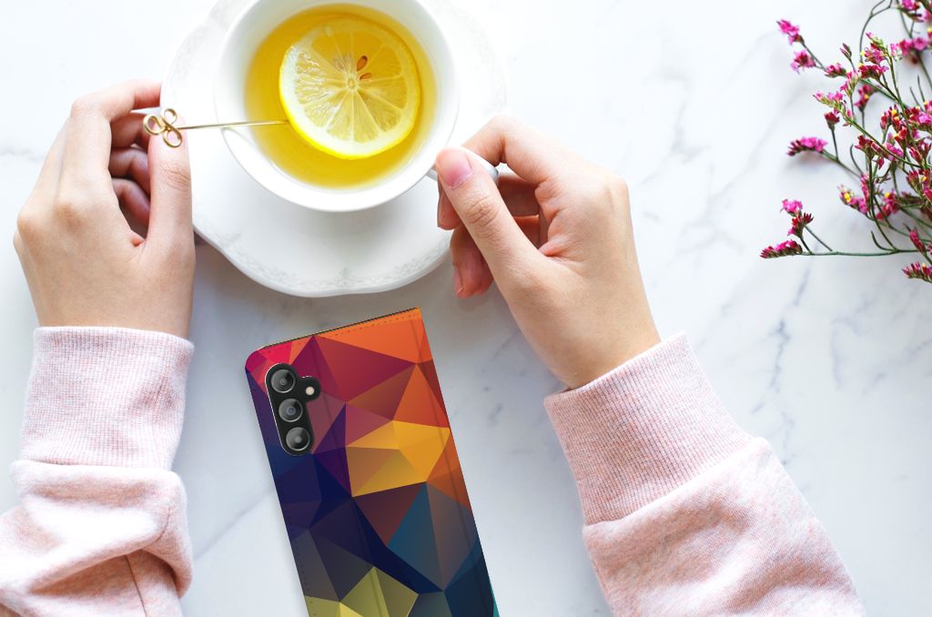 Samsung Galaxy A14 4G Stand Case Polygon Color with colorful geometric patterns next to a cup of tea.