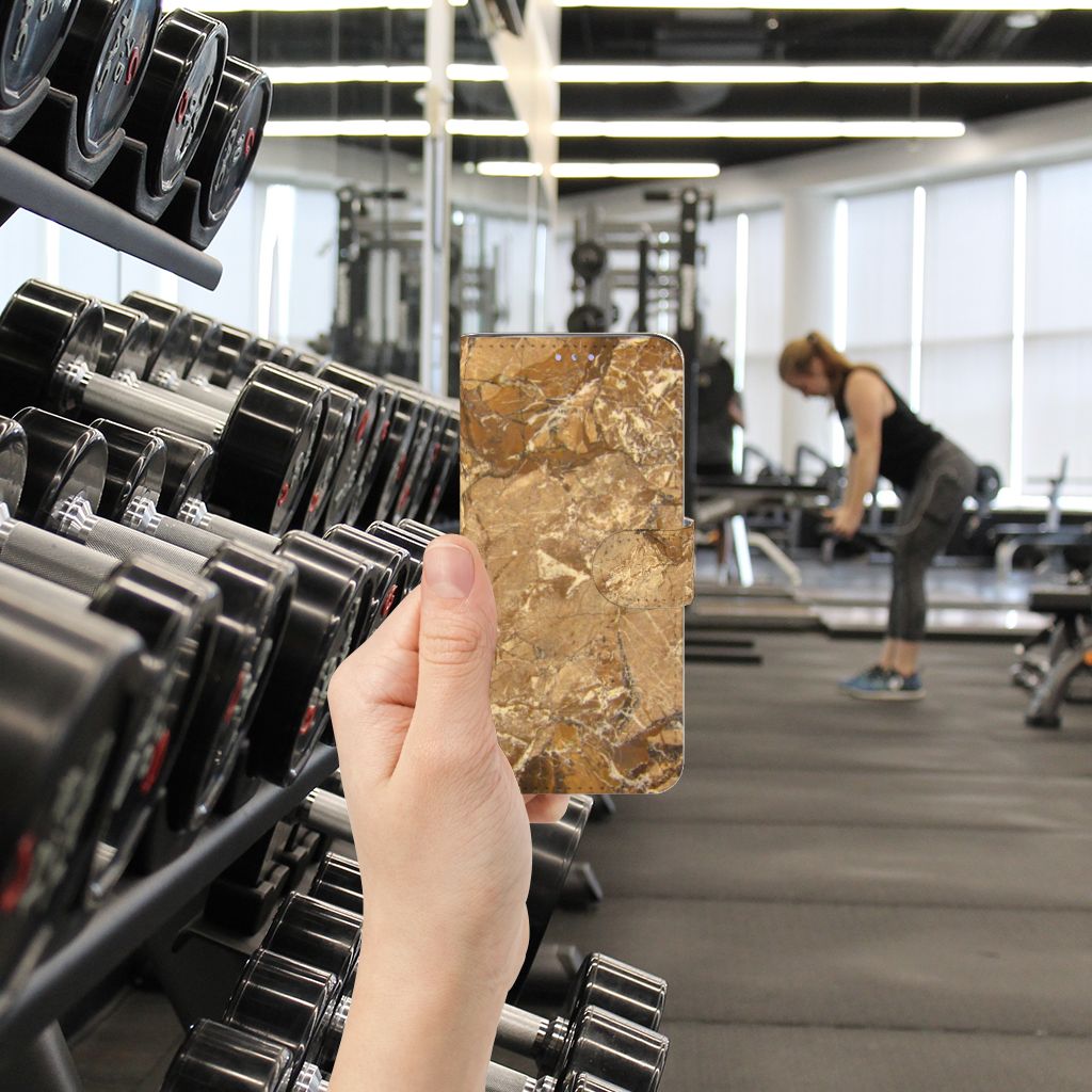 Samsung Galaxy S20 Bookcase Marmer Creme in hand at gym with weights in background.