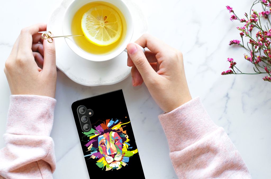 Samsung Galaxy A14 4G Magnet Case Lion Color on a marble surface with a cup of tea and a hand holding a slice of lemon.