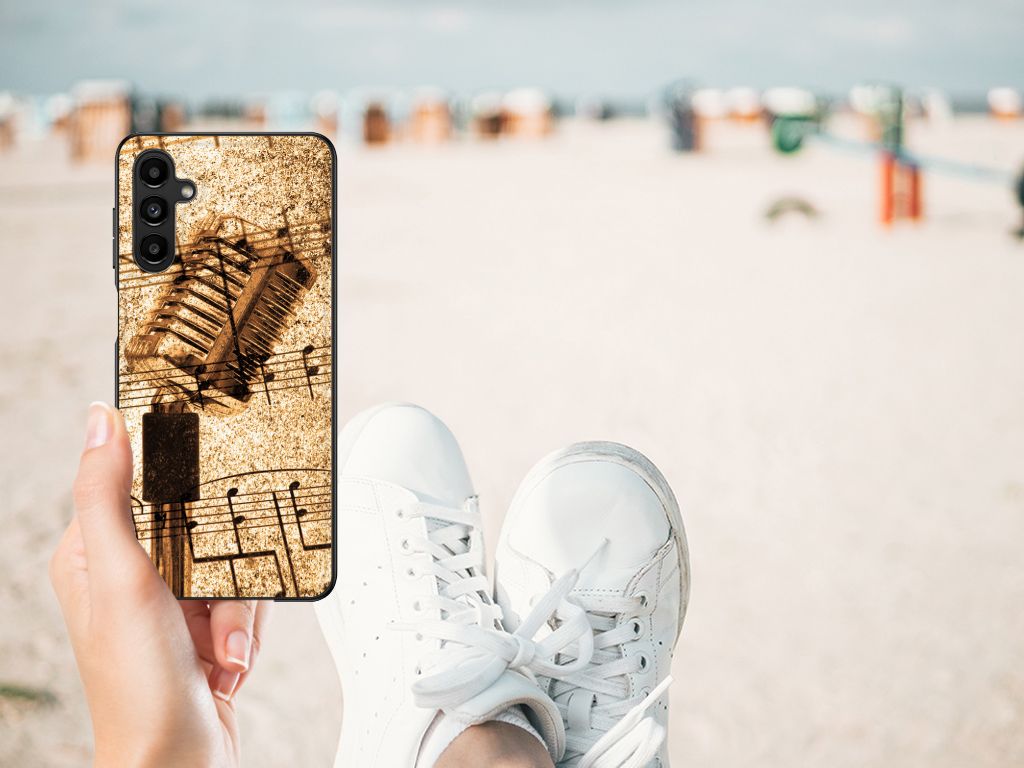 Samsung Galaxy A14 5G Silicone Back Case Bladmuziek shown on a beach with sneakers in the foreground.