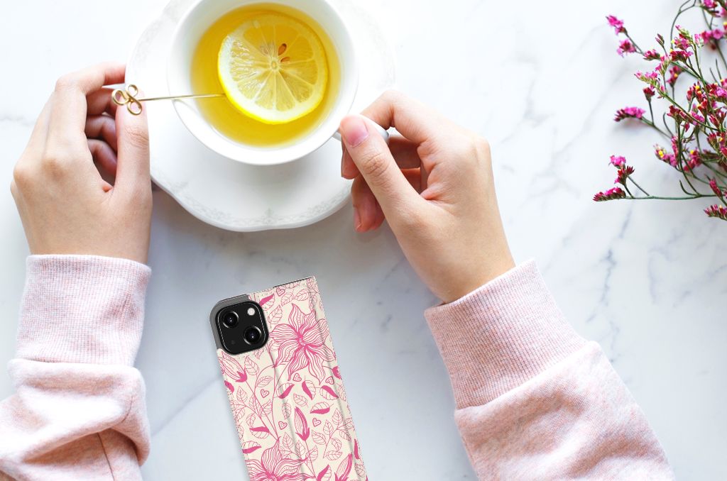 iPhone 13 Mini Smart Cover Pink Flowers in hand beside a cup of tea with lemon đ.