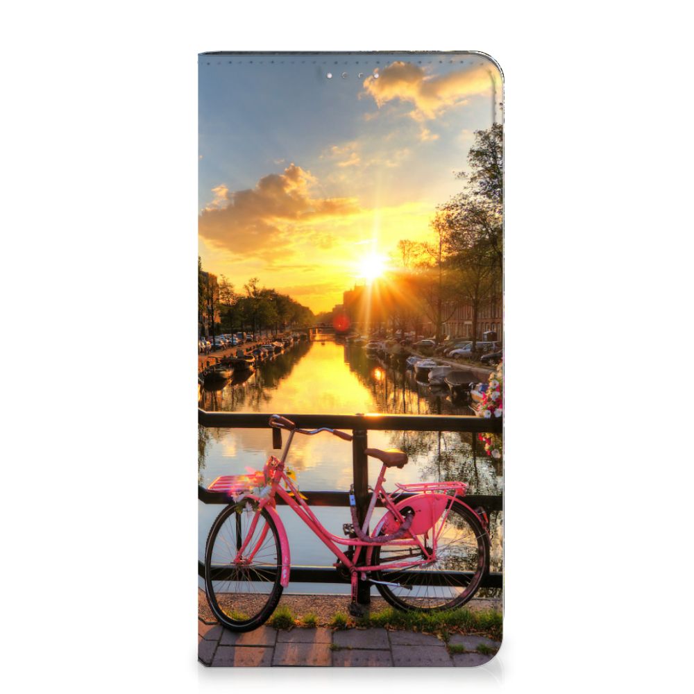 Samsung Galaxy A14 4G Book Cover Amsterdamse Grachten met een fiets voor de grachten van Amsterdam bij zonsondergang