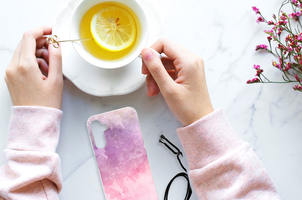 Back Cover Samsung Galaxy A14 5G Pink Purple Paint next to a cup of lemon tea on a marble table.
