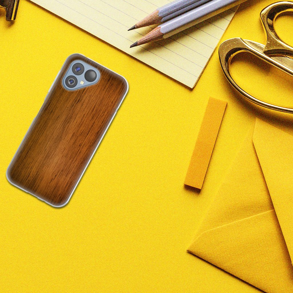 Fairphone 5 Bumper Hoesje Donker Hout op een gele achtergrond met kantoorbenodigdheden, voor stijl en bescherming.