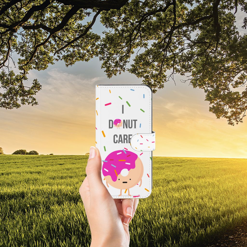 OPPO Reno8 T 5G Book Cover Donut Roze bookcover donut roze voorzijde in hand met sprinkles achtergrond natuur