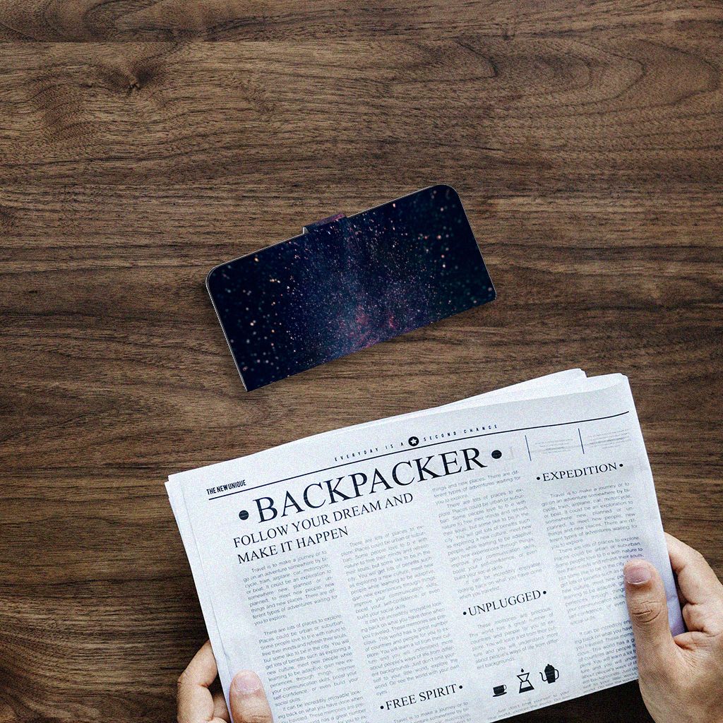 Samsung Galaxy A14 4G Book Case Stars displayed on a wooden table with a newspaper.