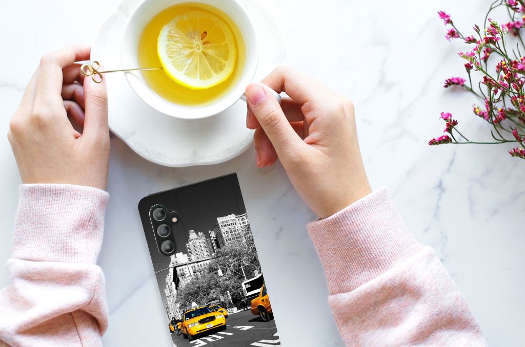 Samsung Galaxy A14 4G Book Cover New York Taxi displayed with tea and flowers.