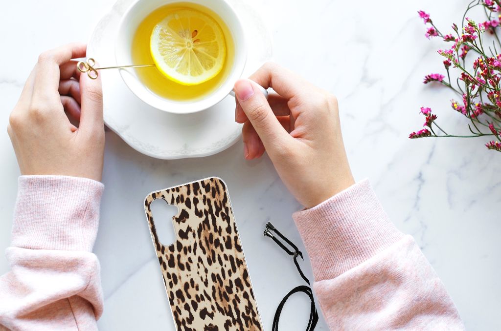 Samsung Galaxy A14 5G Case Anti-shock Leopard on a table with hands and a cup of tea.