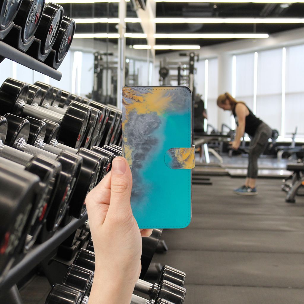 Xiaomi Redmi Note 12 5G | Poco X5 Bookcase Marble Blue Gold in hand at gym, showcasing style and protection.