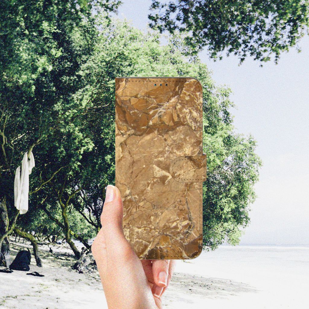 Nokia G50 Bookcase Marmer Creme in hand against a natural background with trees.