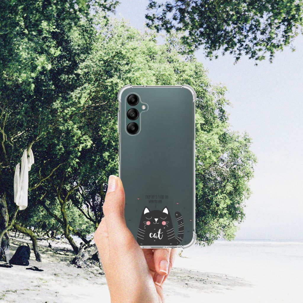 Samsung Galaxy A14 5G/4G Stevig Bumper Hoesje Cat Good Day in hand against a scenic beach background.
