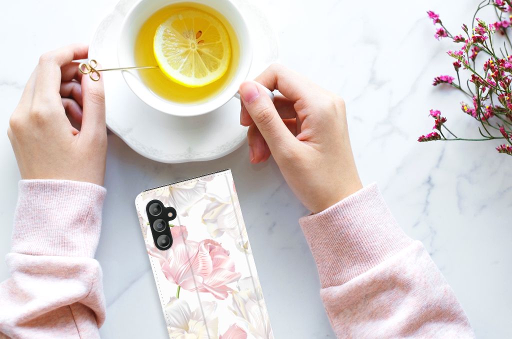 Samsung Galaxy A14 4G Smart Cover Lovely Flowers next to a cup of lemon tea with hands holding the cup.