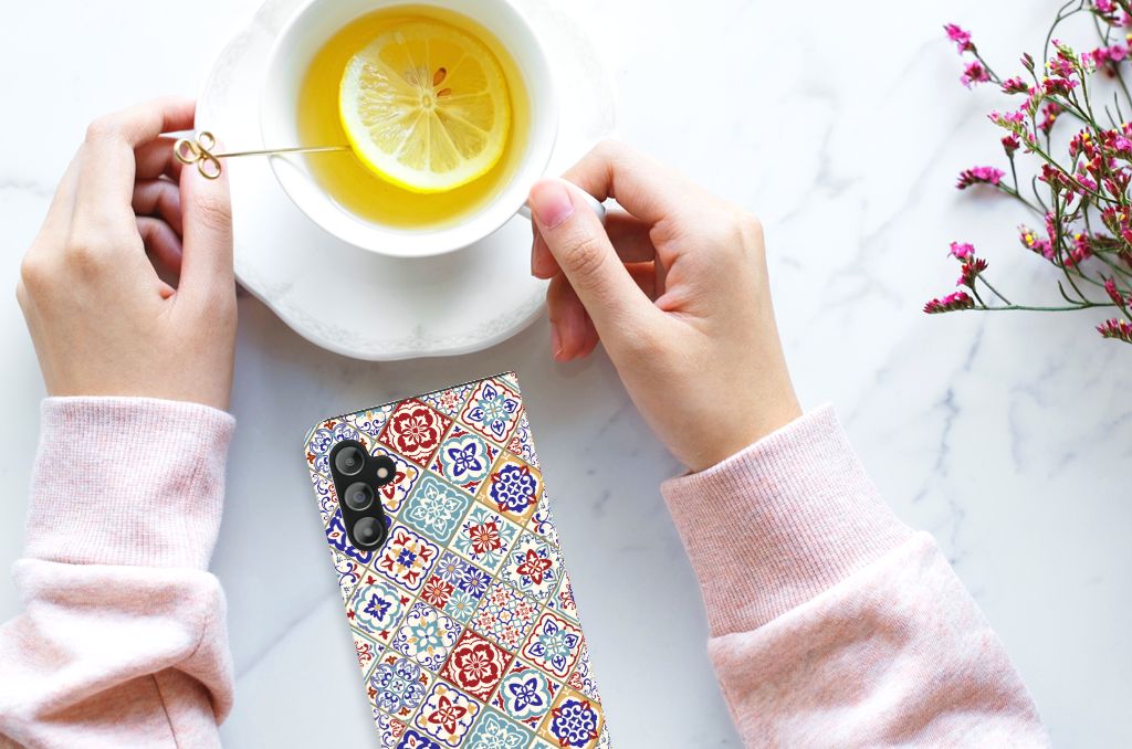 Samsung Galaxy A14 5G Standcase Tiles Color displayed with a cup of lemon tea and flowers.