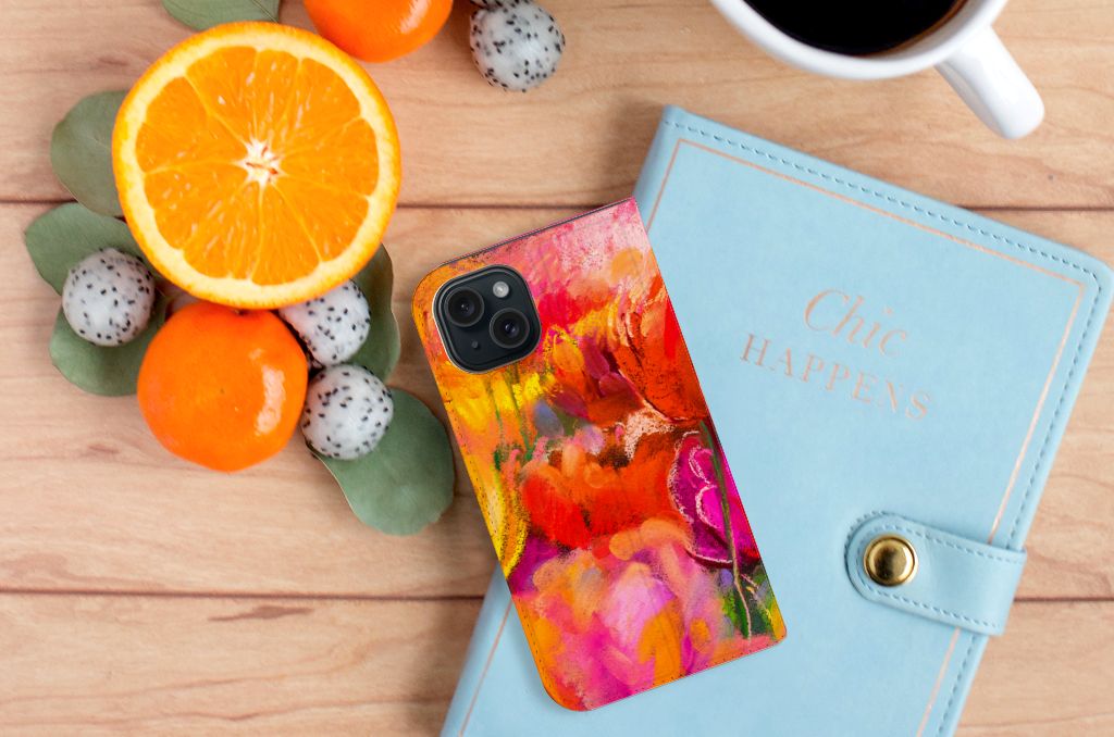 Bookcase iPhone 15 Tulips design on a colorful background with fruits and a notebook.