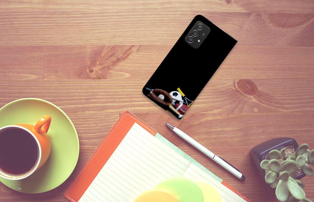 Samsung Galaxy A52 Hippe Standcase Sports on a wooden desk with a cup and notebook