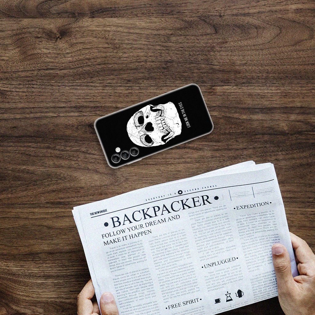 Silicone Back Case Samsung Galaxy A14 5G Skull Eyes displayed on a wooden table with newspaper.