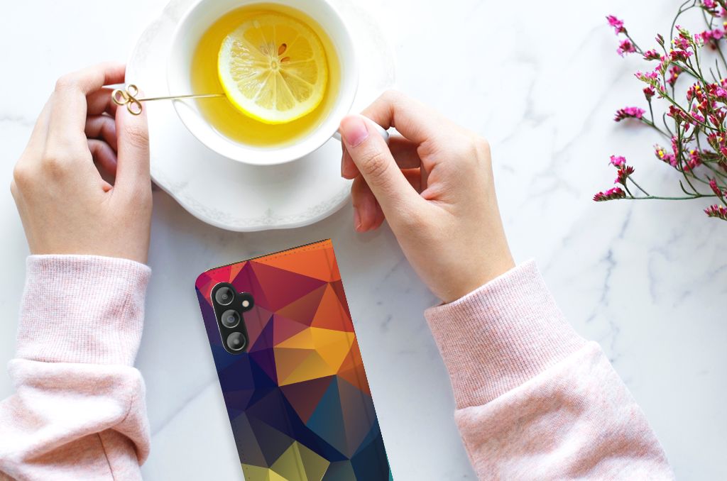 Samsung Galaxy A14 5G Stand Case Polygon Color displayed next to a cup of tea with lemon.