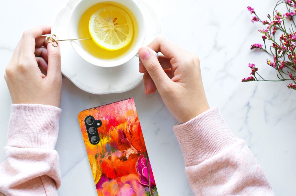 Bookcase Samsung Galaxy A14 4G Tulips design displayed with a cup of tea and lemon on a marble table.