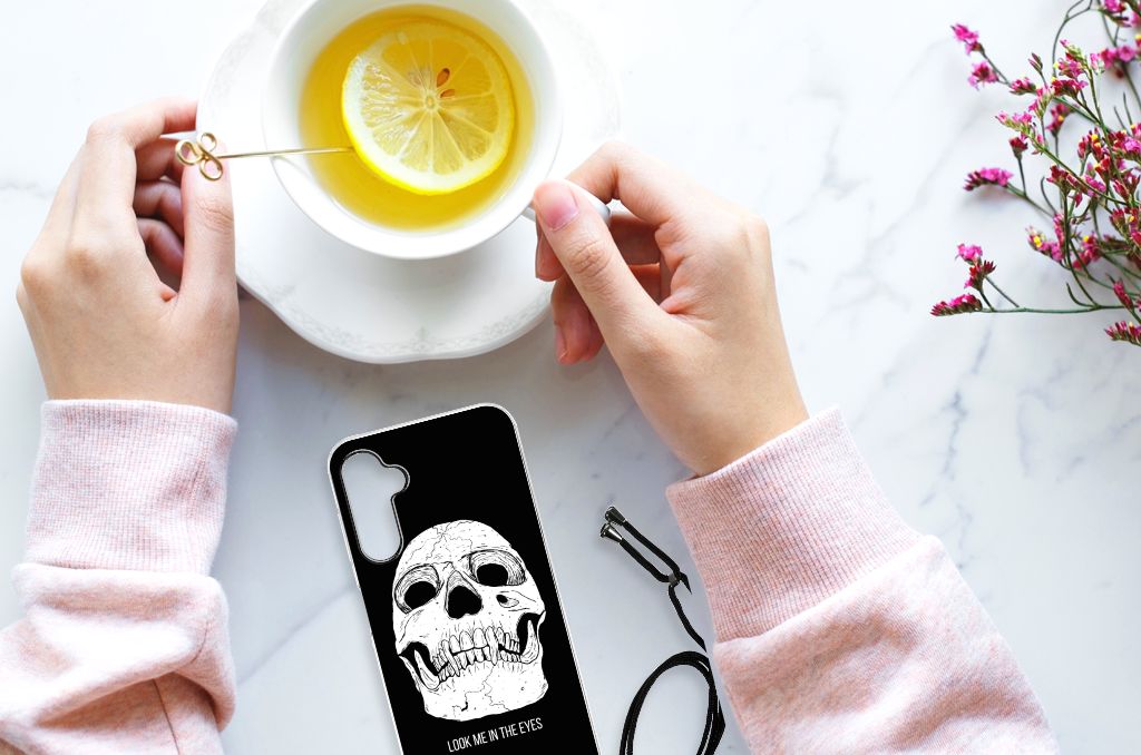 Extreme Case Samsung Galaxy A14 5G Skull Eyes displayed with a cup of tea and lemon on a marble surface.