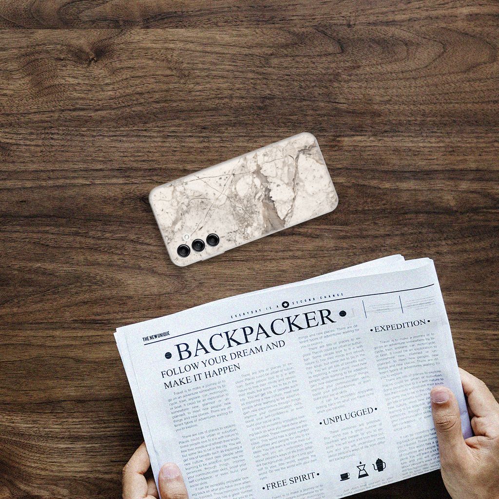 Samsung Galaxy A14 5G TPU Siliconen Hoesje Marmer Beige op een houten tafel met een krant.