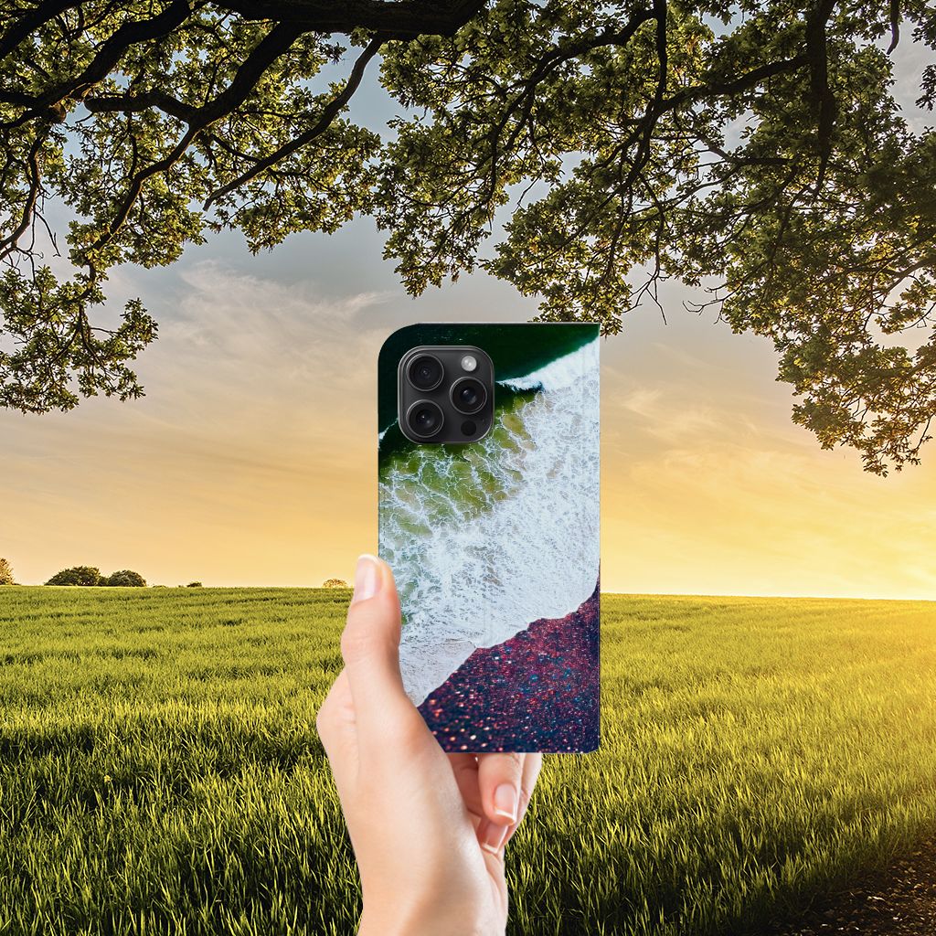 Hand holding an iPhone 15 Pro Max Stand Case Sea in Space with beach and sunset background đ
.