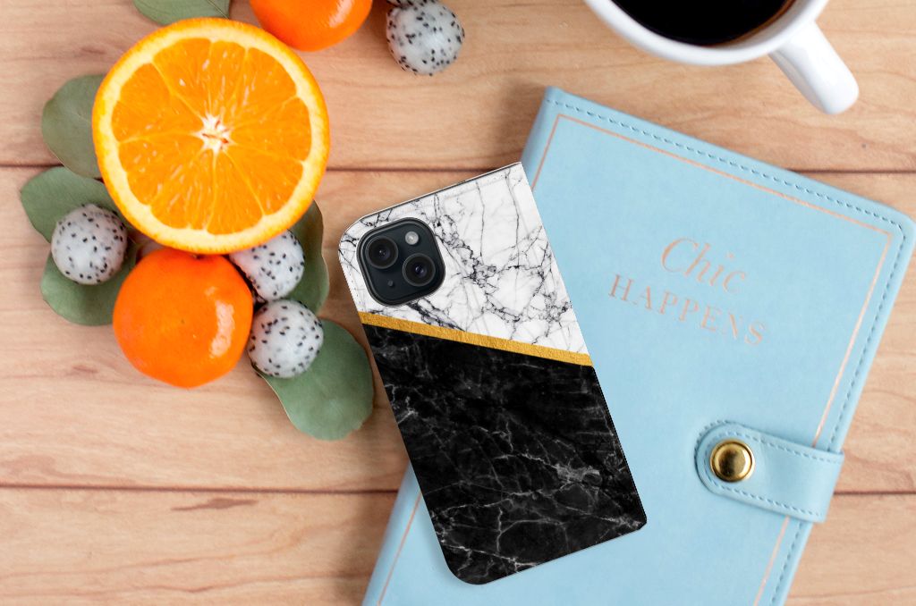 iPhone 15 Standcase Marmer Wit Zwart - Origineel Cadeau Man met zwartwit marmeren design en gouden accent naast fruit.
