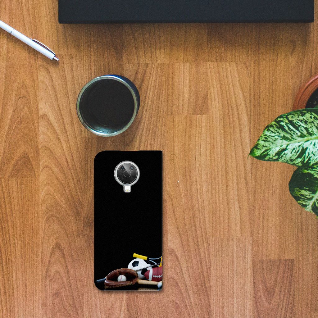 Nokia G10 | G20 Hippe Standcase Sports with various sports designs on a wooden table.