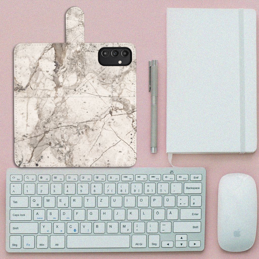 Samsung Galaxy A14 5G Bookcase Marmer Beige op een bureau met toetsenbord en muis.