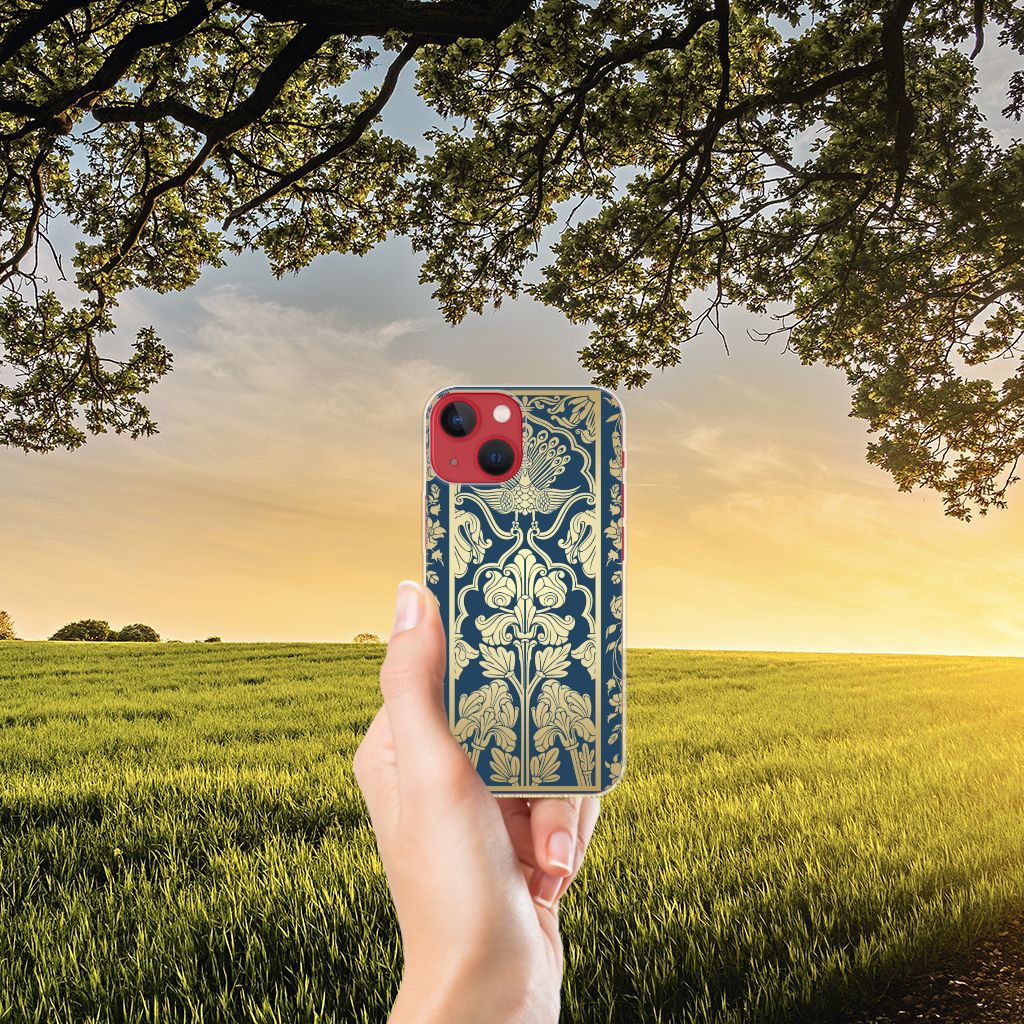 Apple iPhone 13 TPU Case Beige Flowers in hand against a scenic sunset background with lush fields.