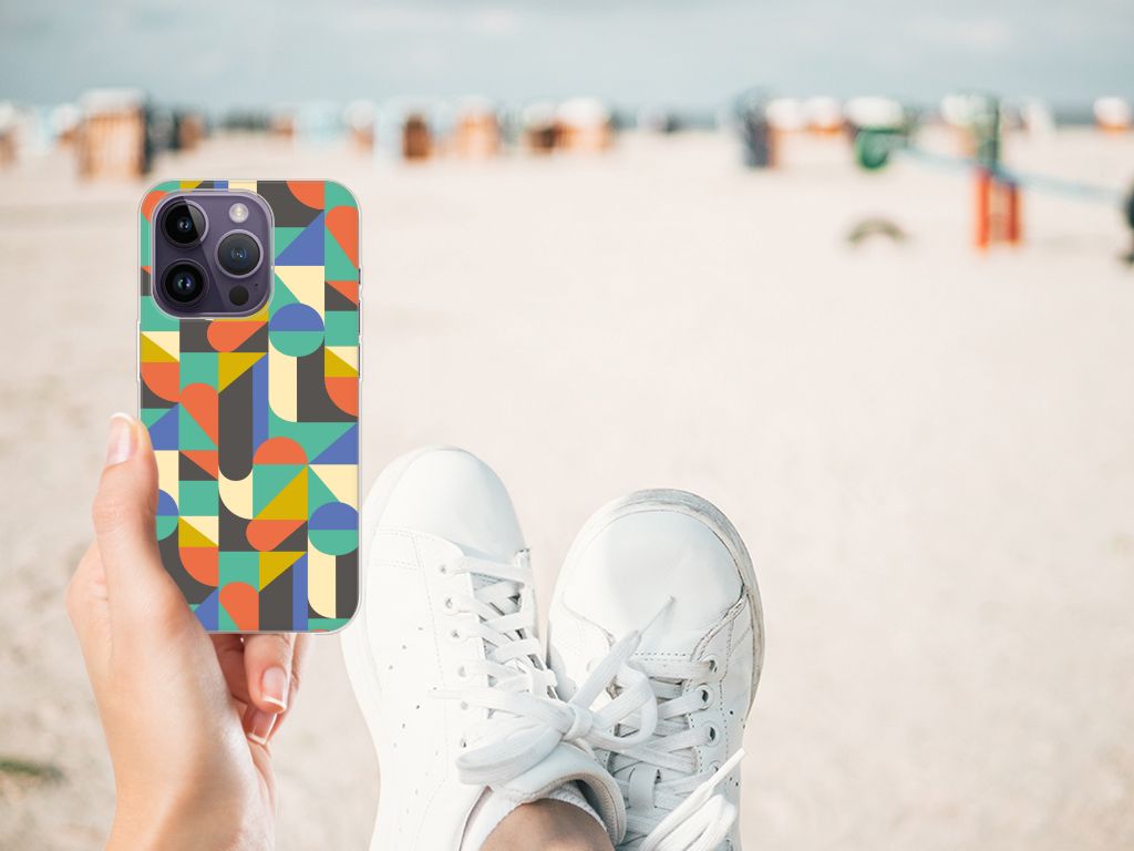 Apple iPhone 14 Pro TPU bumper Funky Retro case in colorful geometric design held on a beach.