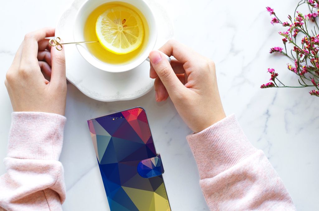 Samsung Galaxy A14 5G Book Case Polygon Dark with hands holding a cup of tea on a marble table.