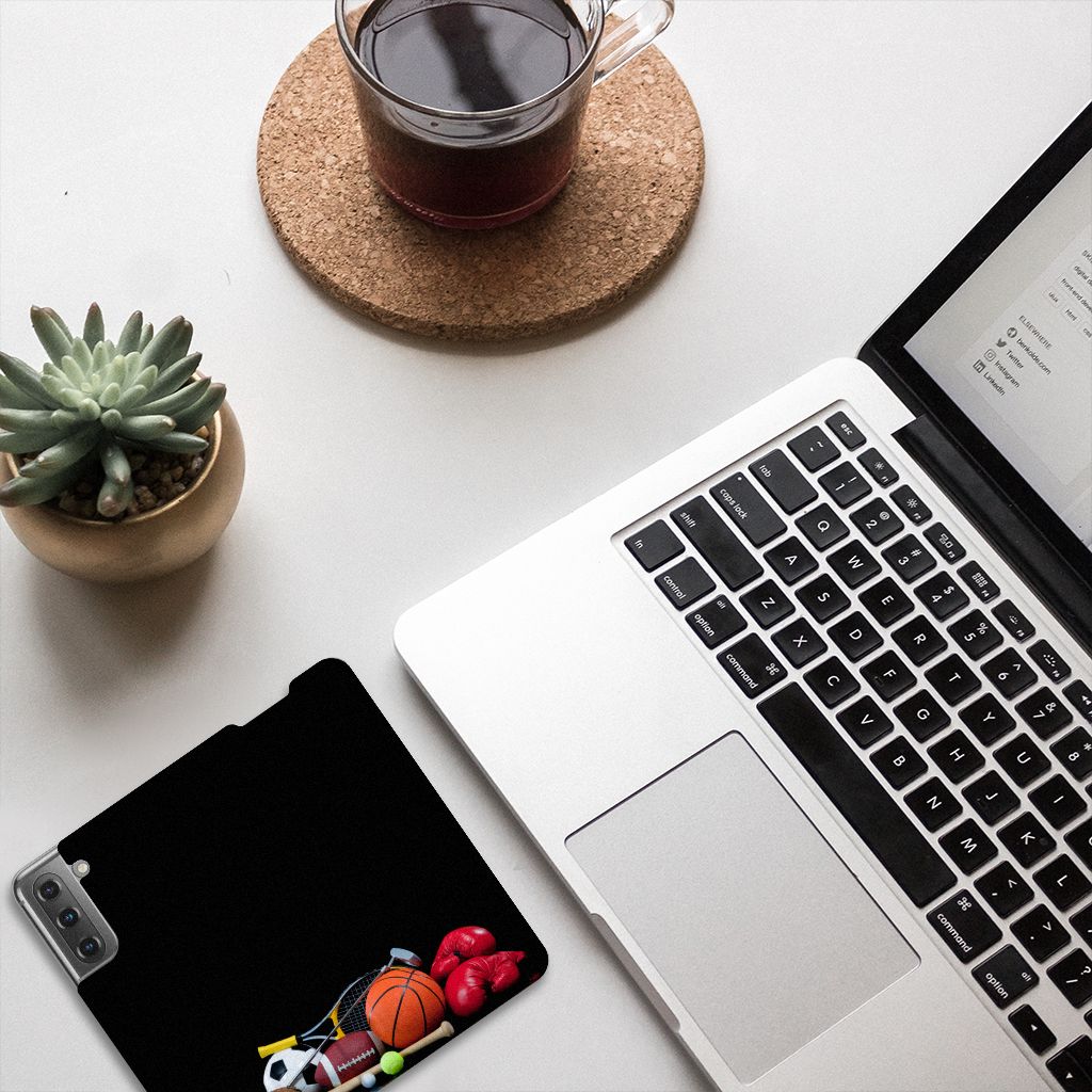 Samsung Galaxy S21 FE Hippe Standcase Sports displayed on desk with sports items, laptop, and coffee.