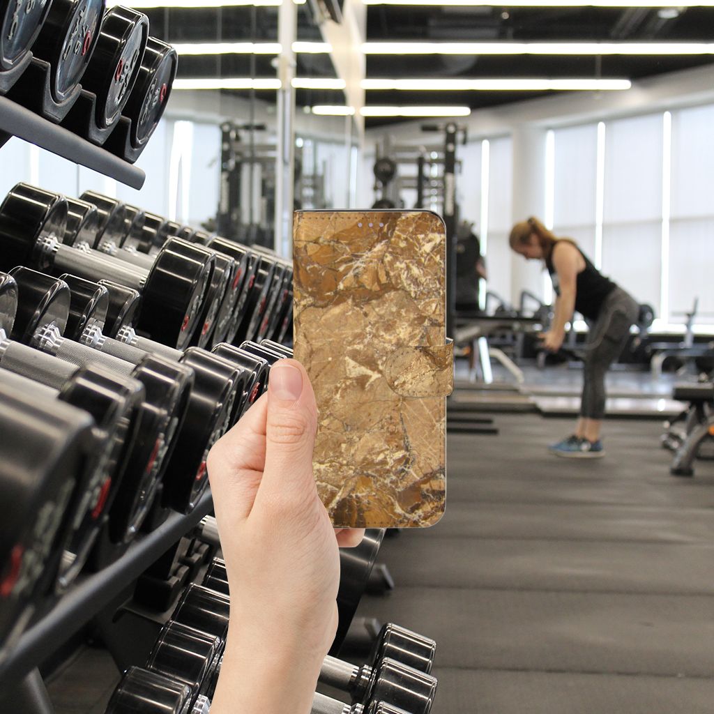 OnePlus Nord CE 5G Bookcase Marmer Creme in a gym setting showcasing its luxury marble design.