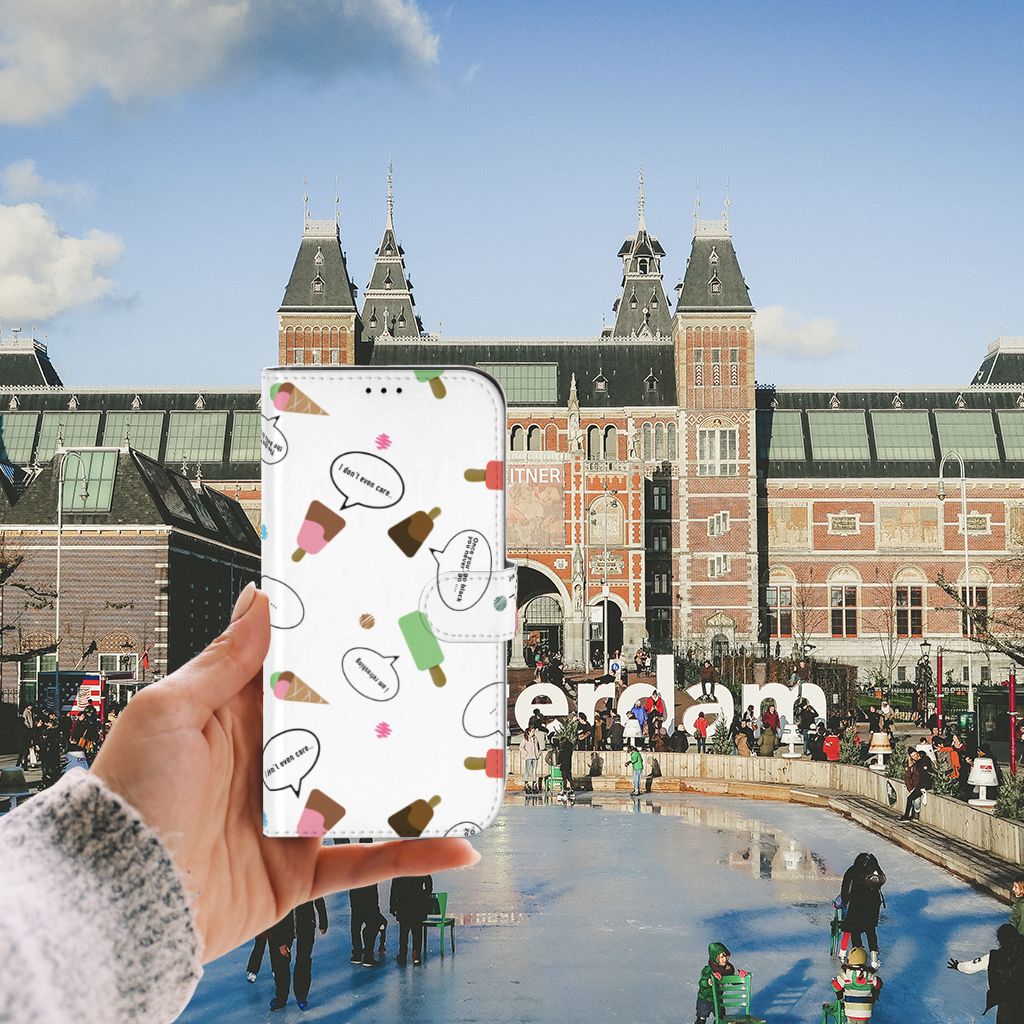 Hand holding an iPhone 13 Pro Max Book Cover IJsjes in front of the Rijksmuseum in Amsterdam.