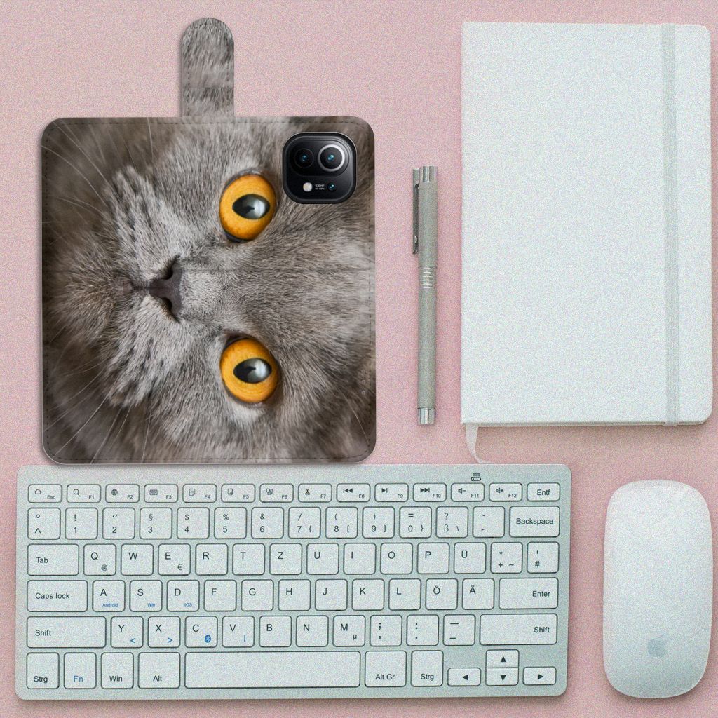 Telefoonhoesje met Pasjes Xiaomi Mi 11 Britse Korthaar afgebeeld met een grijze kat met gele ogen op een bureau.