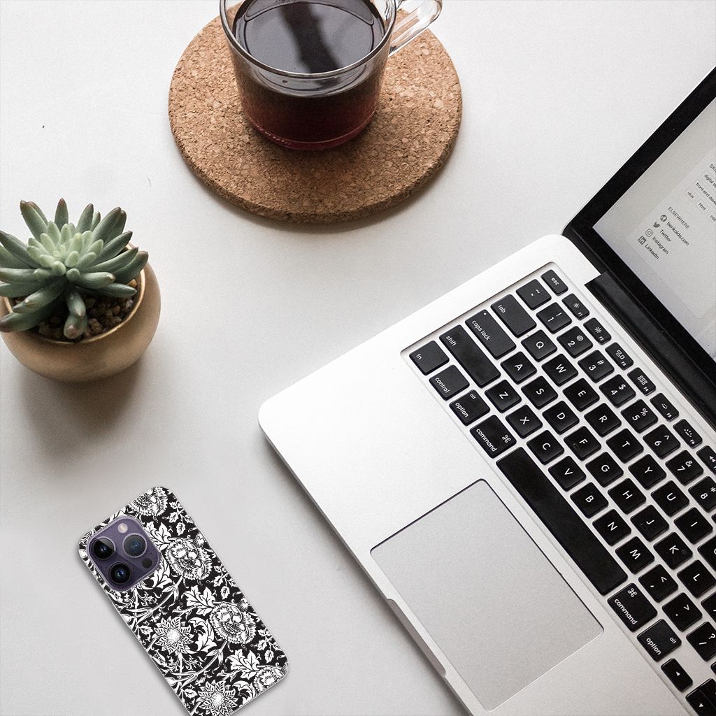 Apple iPhone 14 Pro TPU Case Black Flowers in a stylish desk setup with coffee and a plant.