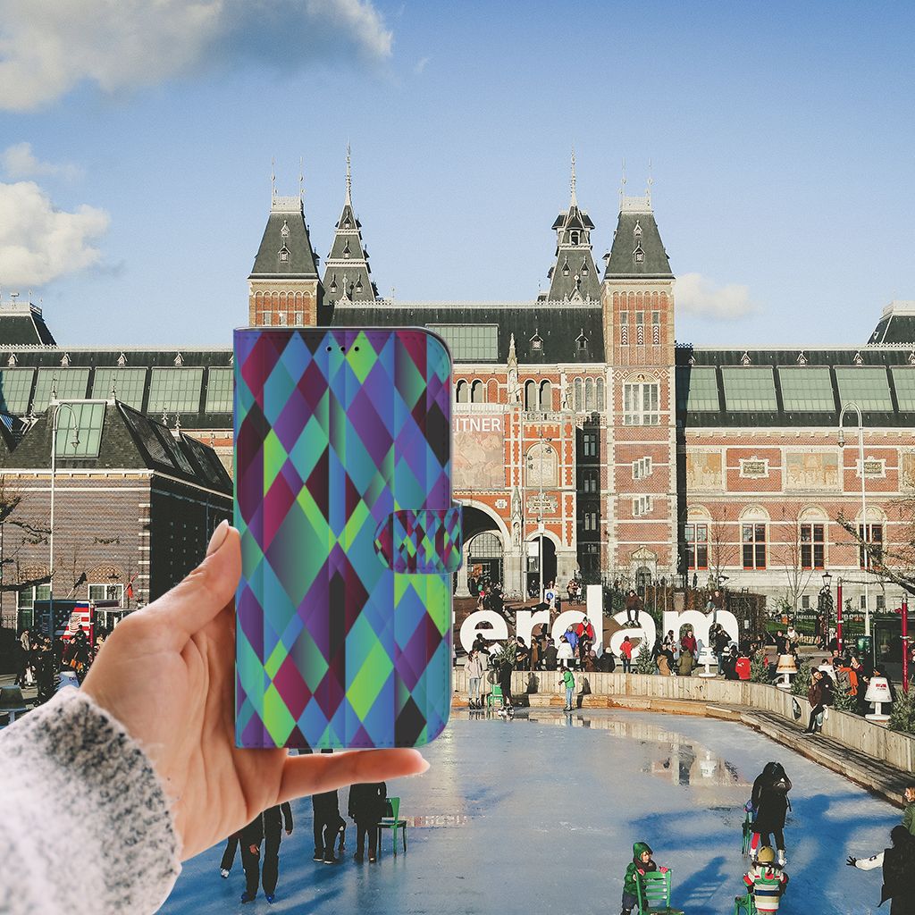 iPhone 13 Pro Max Book Case Abstract Green Blue held in front of Amsterdam museum, featuring a vibrant art design.