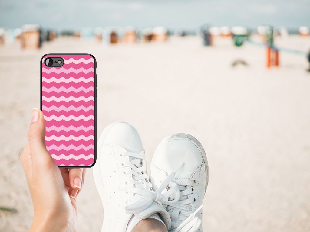 iPhone SE 2022 | SE 2020 | 7/8 Back Case Waves Pink held by a person in white sneakers on a beach.