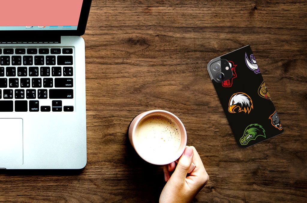 iPhone 12 | iPhone 12 Pro Magnet Case Cartoon with colorful designs on a wooden desk next to a laptop and coffee mug.