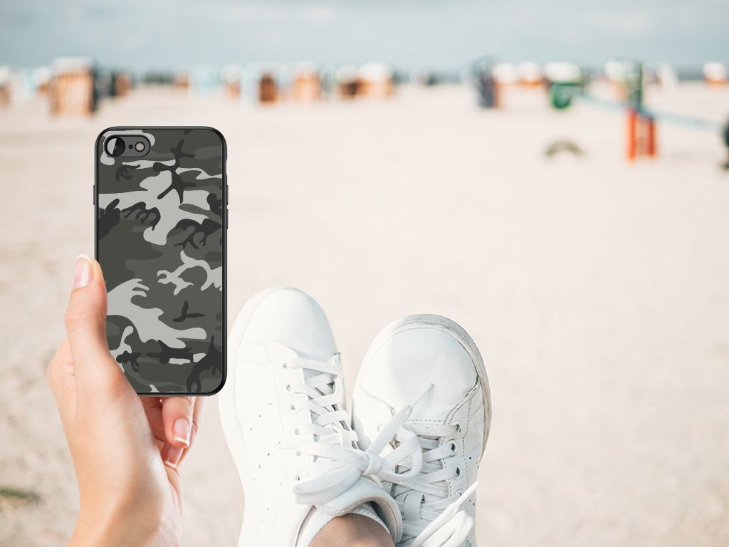 iPhone SE 2022 | SE 2020 | 7/8 Back Case Army Light displayed on a hand with white sneakers on a beach.