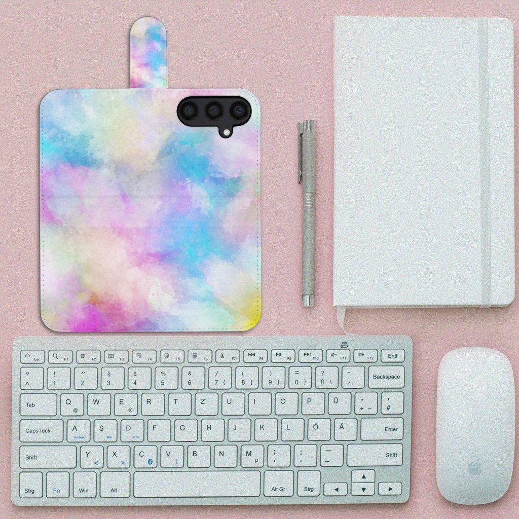 Hoesje Samsung Galaxy S24 Watercolor Light met pastelkleuren, geplaatst naast een toetsenbord en notitieboek.